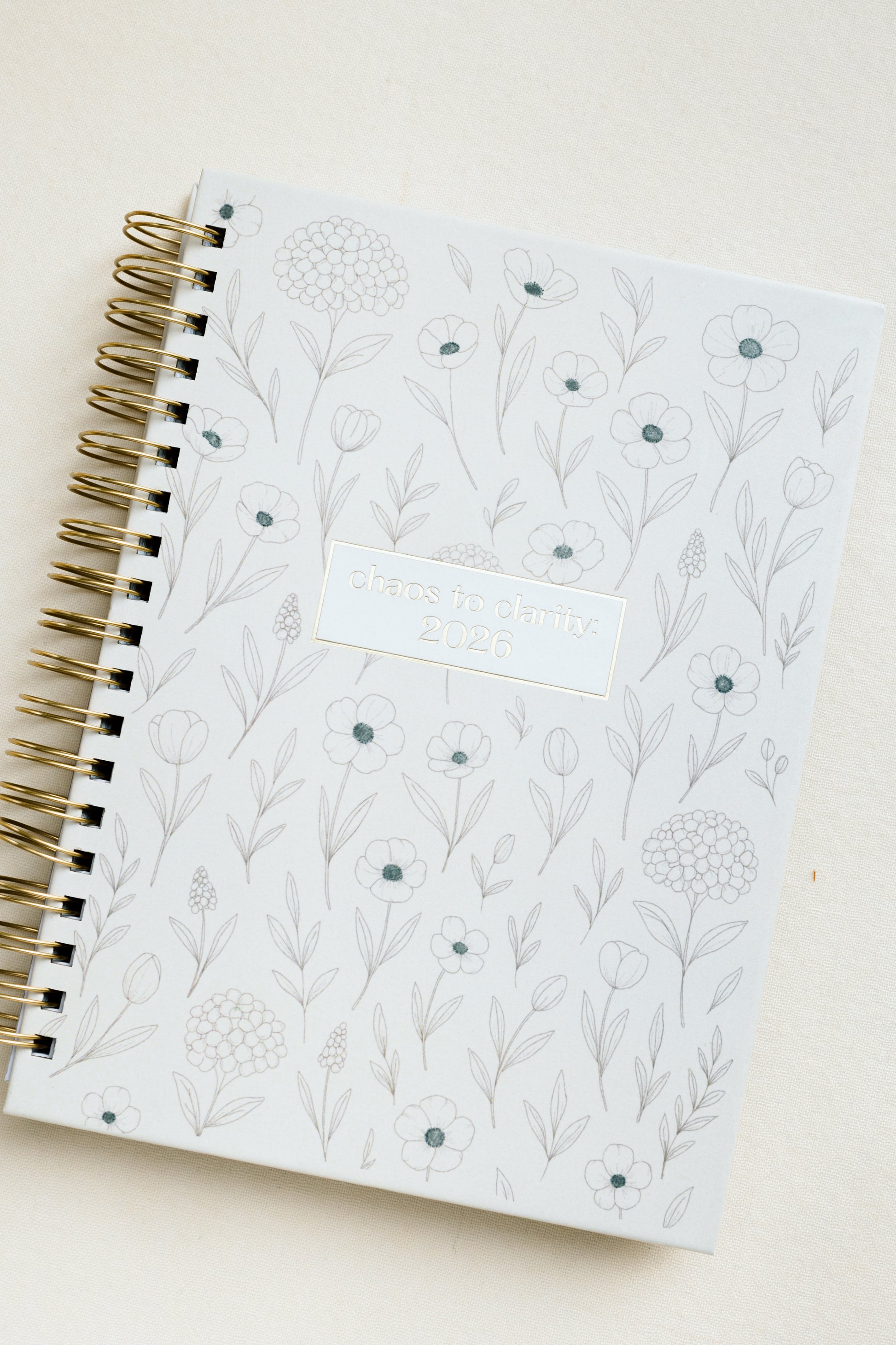 Spiral-bound notebook with floral pattern on a light background